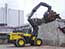 Wheel loader that carries logs to high places (High lift log grapple)