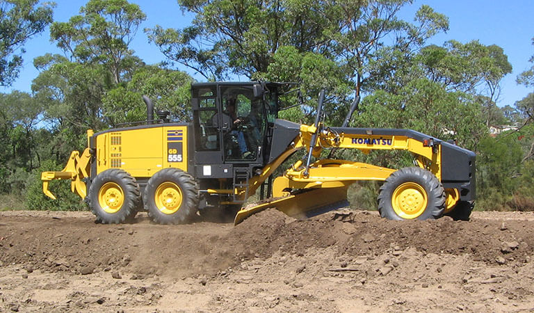 Machine that makes foundation of roads (Motor grader)