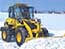 Wheel loader which removes snow